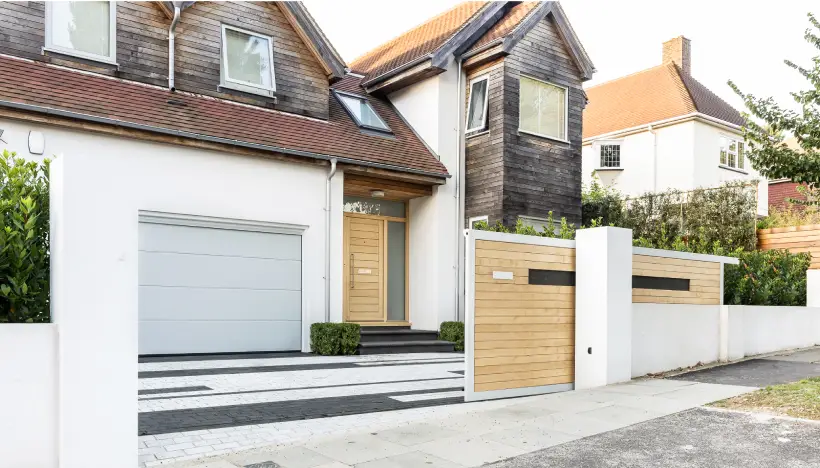 A gate beginning to close in front of a house in Brighton